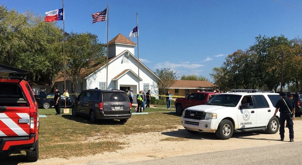 A gathering outside of a small white church in Sutherland Springs.